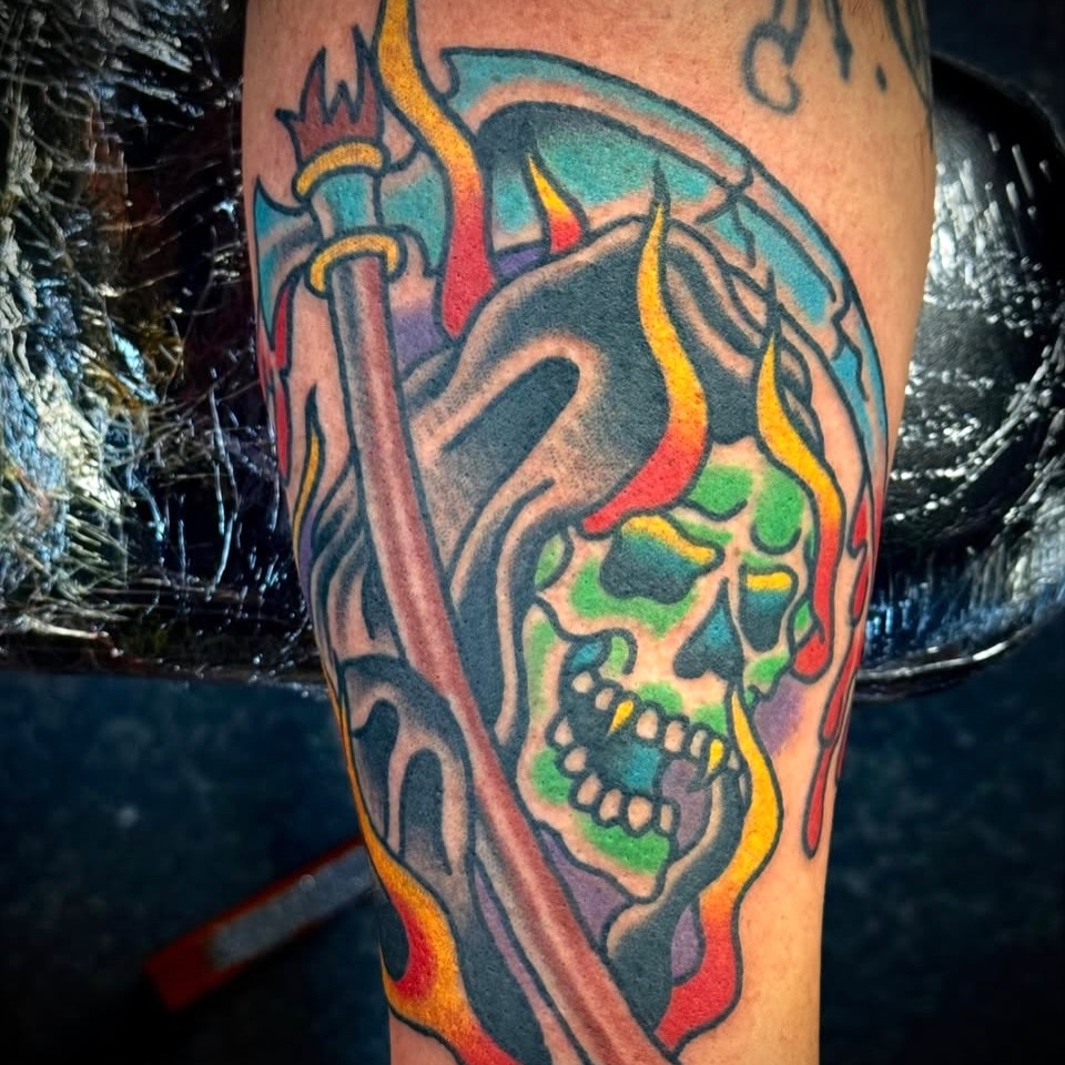 Flaming skull American traditional tattoo on the forearm by Sam Hambrick, Watchung NJ