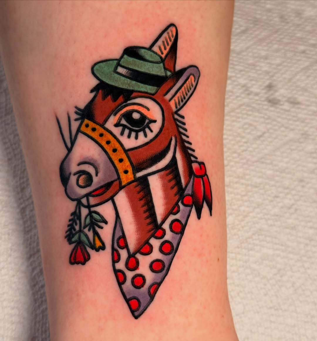 Donkey wearing hat American traditional tattoo on the forearm by {{Theo Glanton}}