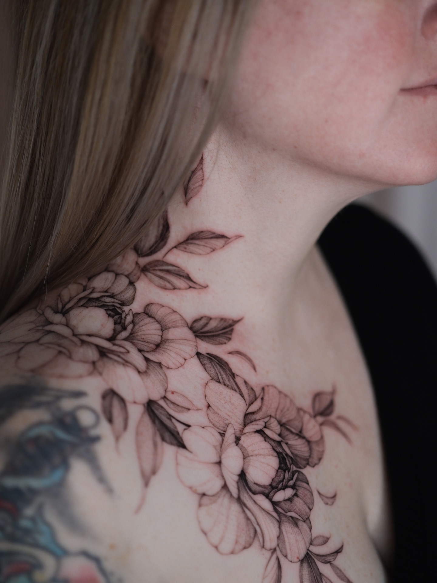 Floral arrangement black and grey tattoo on the shoulder by Tattoo artist in Boston