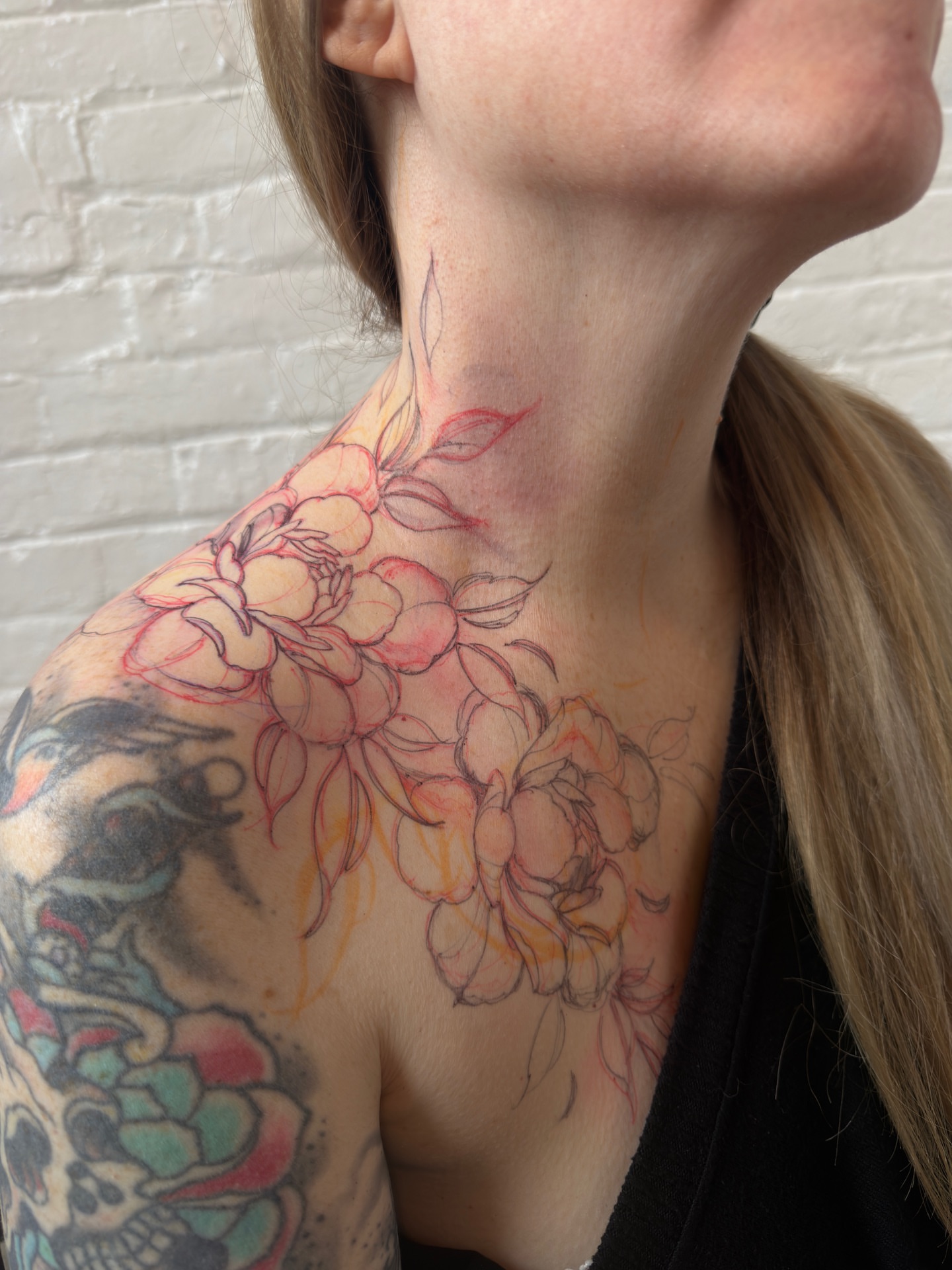 Floral bouquet watercolor tattoo on the shoulder by Tattoo artist in Boston