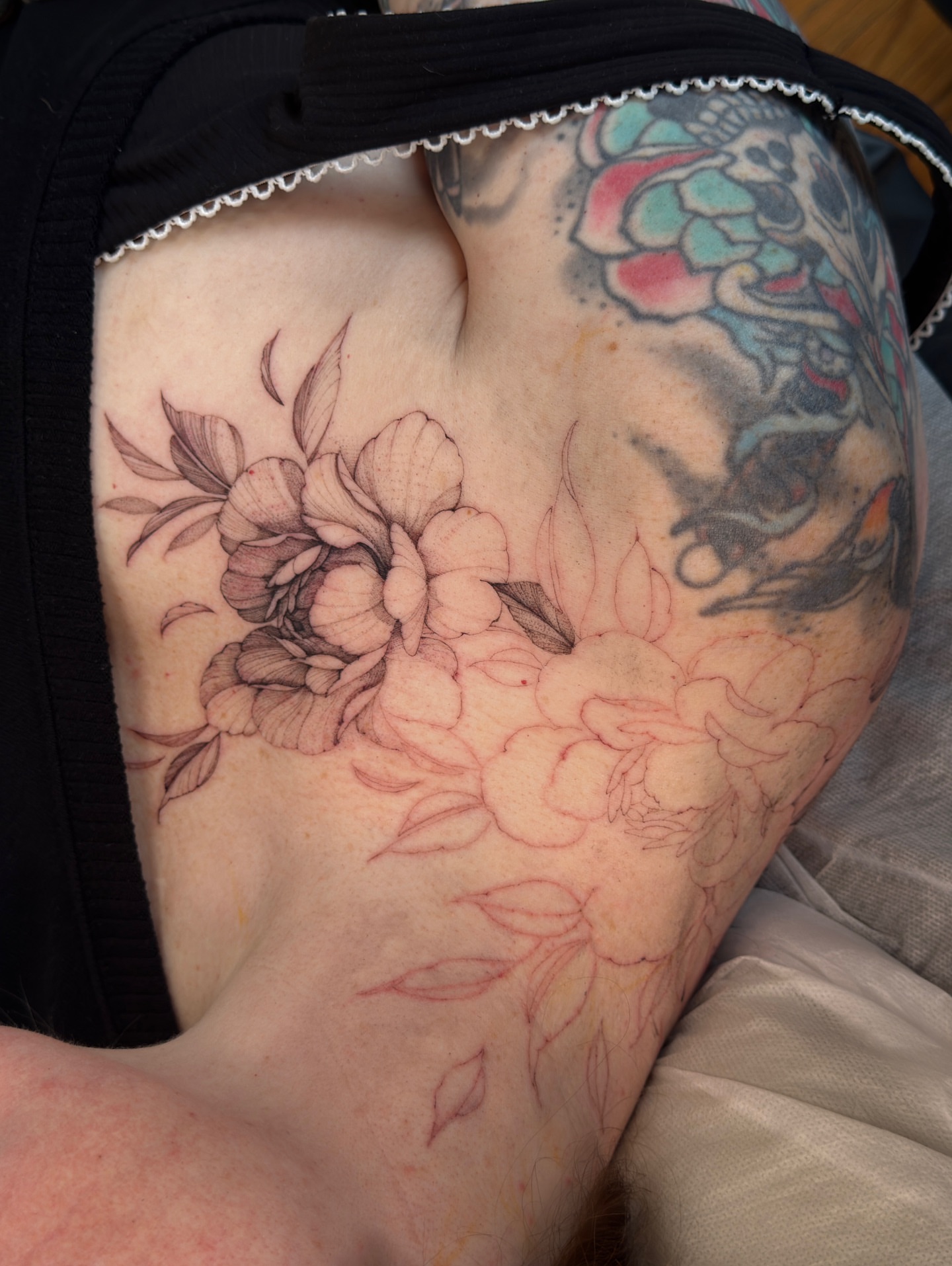 Peony flowers black and grey tattoo on the thigh by Tattoo artist in Boston