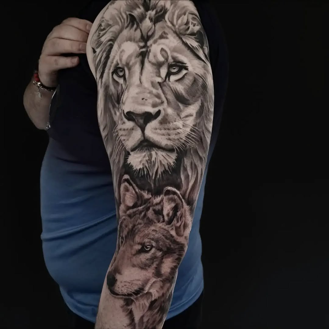 Lion and wolf portrait realism tattoo on the forearm by Lindsay