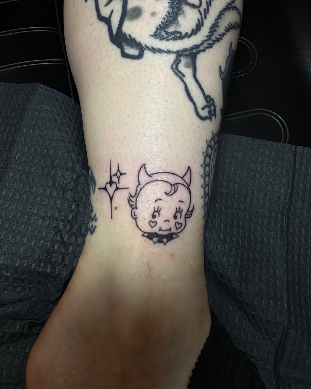 Devil baby with stars fine line tattoo on the forearm by Joe Khay, Hackettstown, New Jersey