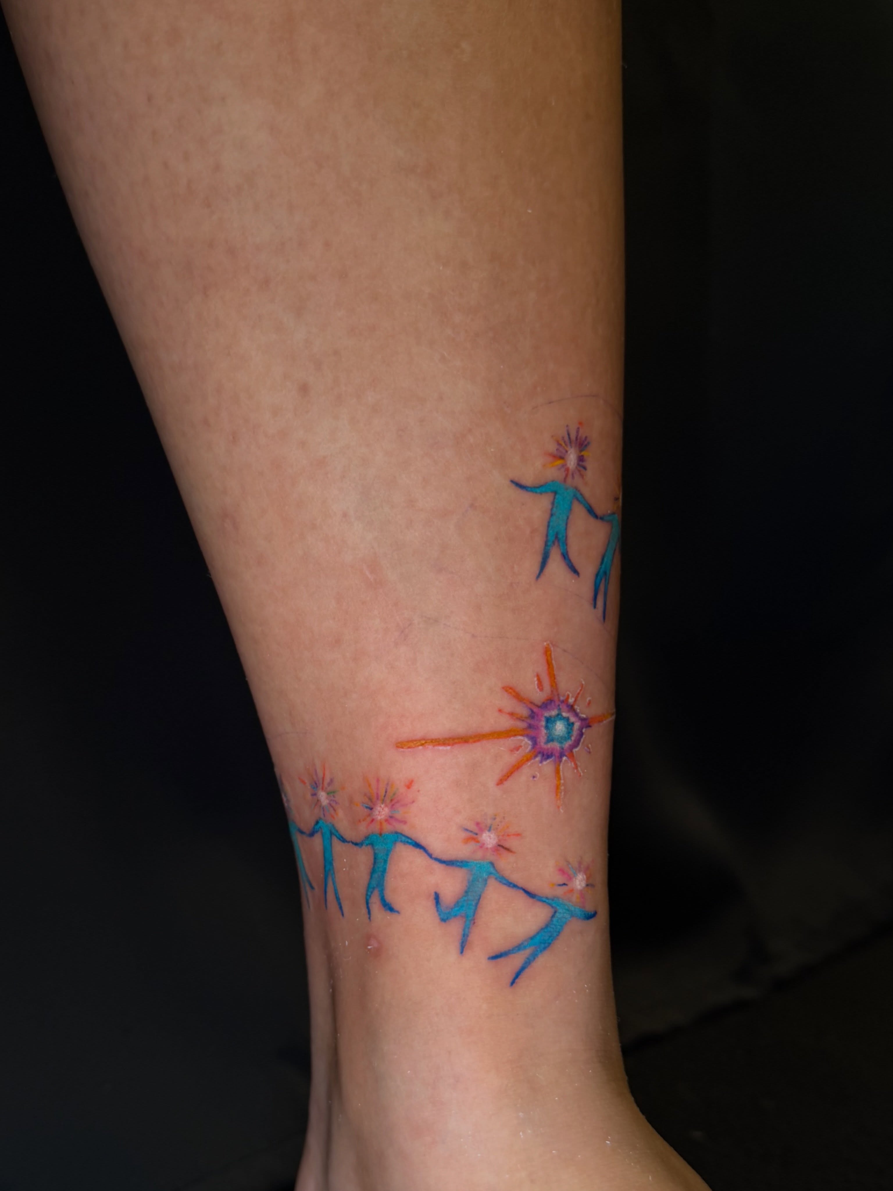 Dancers with starburst watercolor tattoo on the calf by Hues 🦤 Clarksville Fine Line and Blackwork