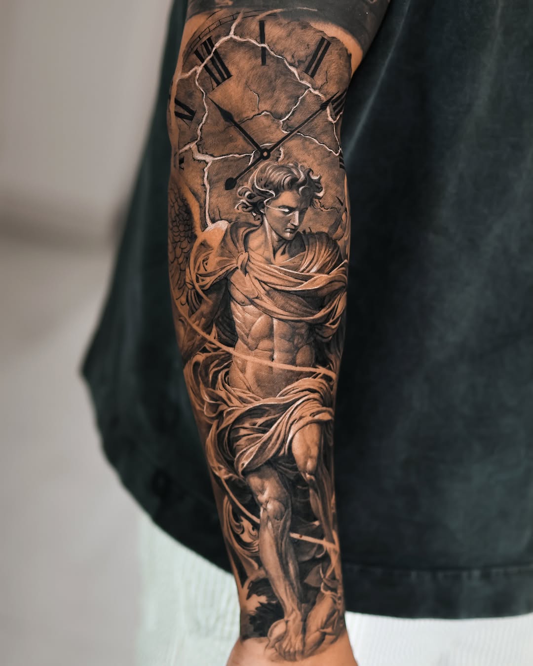 Angelic figure with clock realism tattoo on the forearm by Reset tattoo