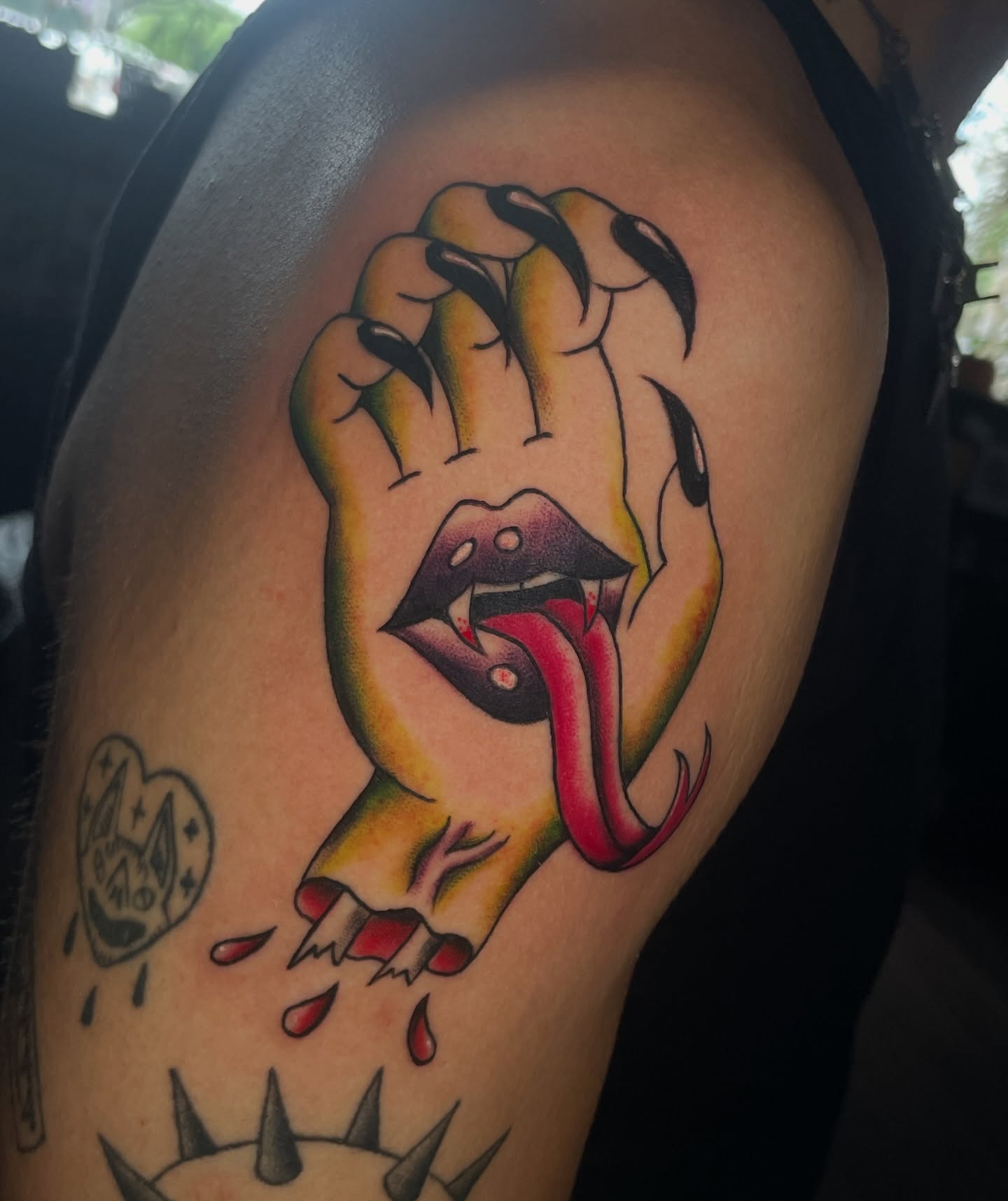 Fist with mouth American traditional tattoo on the shoulder by Marie π Tattoos
