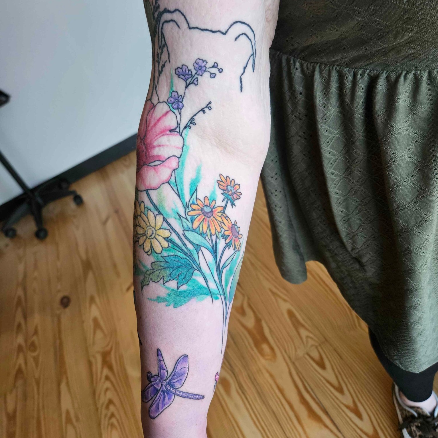Floral arrangement watercolor tattoo on the forearm by Iram Withencroft