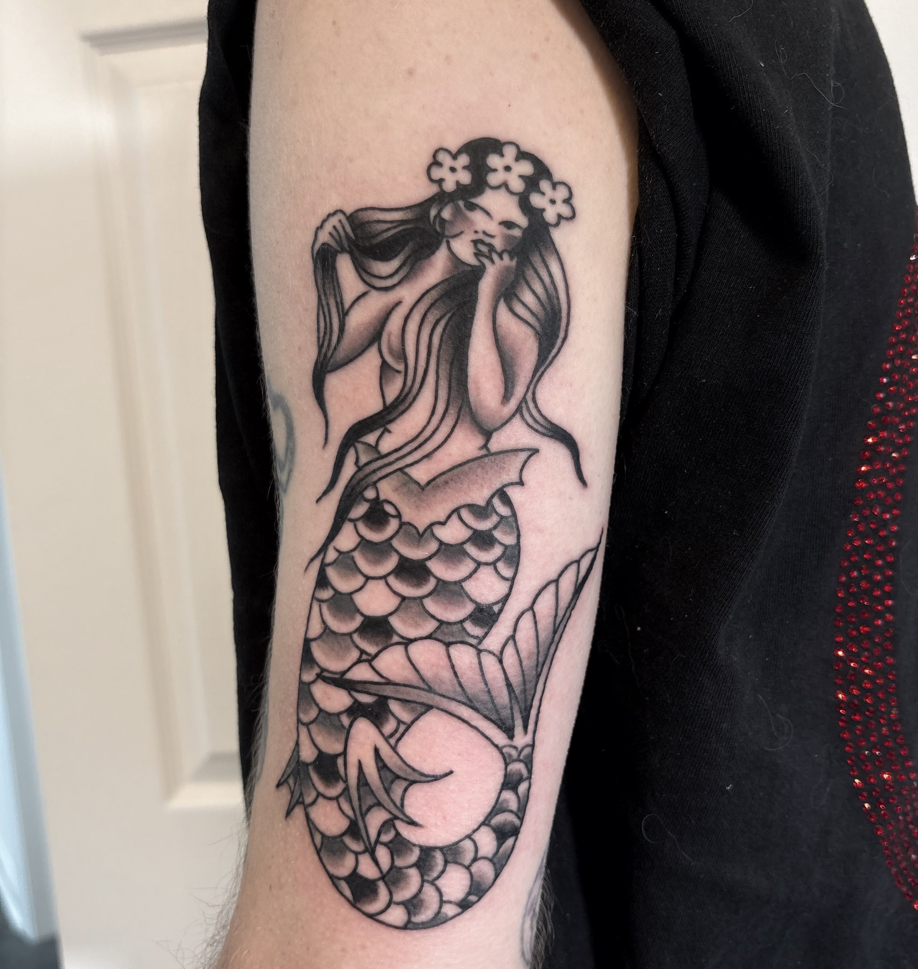 Mermaid black and grey tattoo on the forearm by Caeli Martin