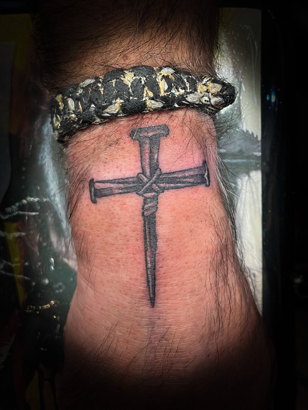 Nail cross tattoo on the forearm by Melissa Peña NYC