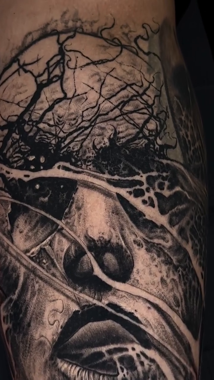 Surreal face with branches dark art tattoo on the forearm by Jesse White, Mentor, Ohio