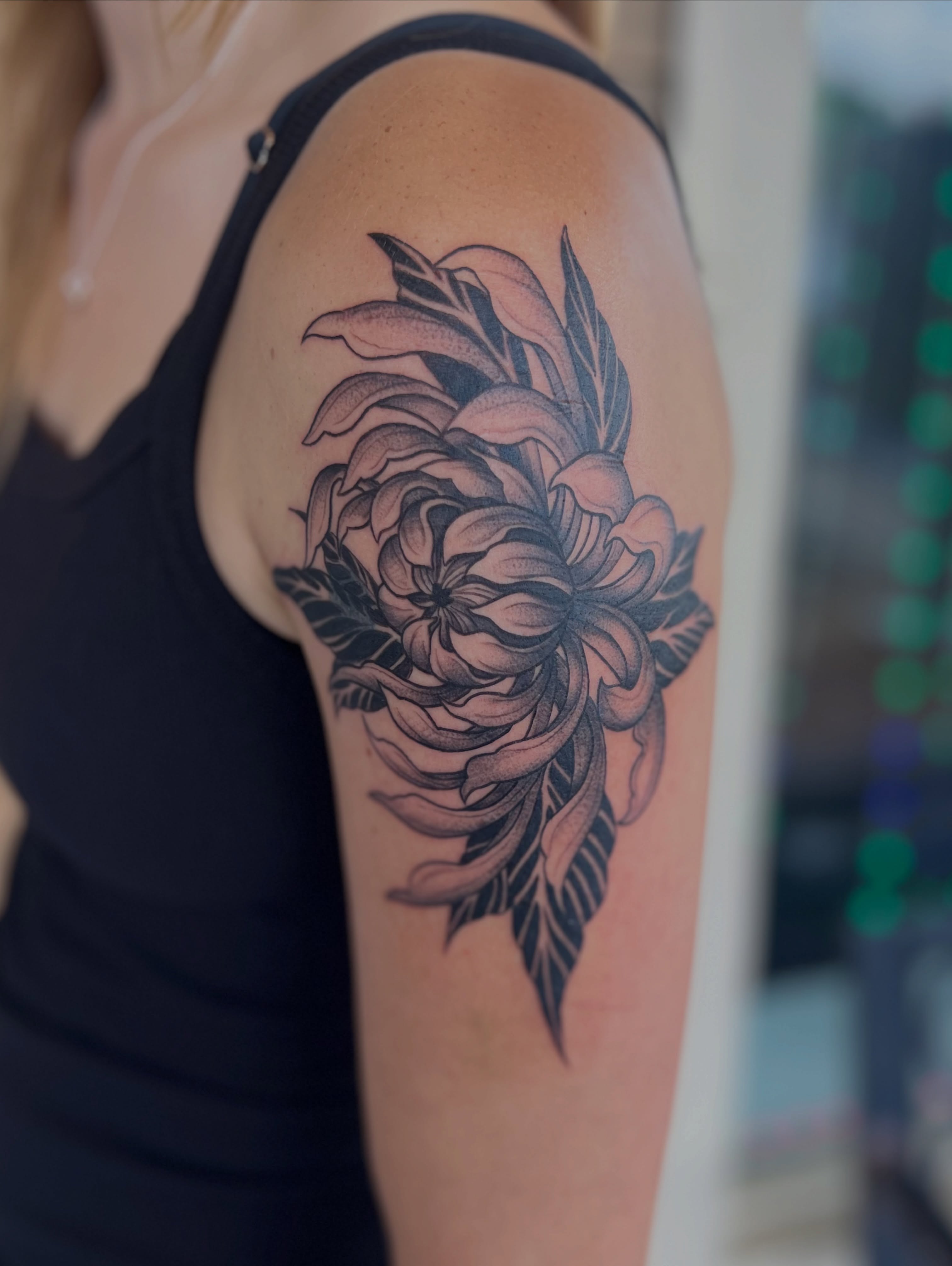 Flower dotwork tattoo on the shoulder by Jai Woods