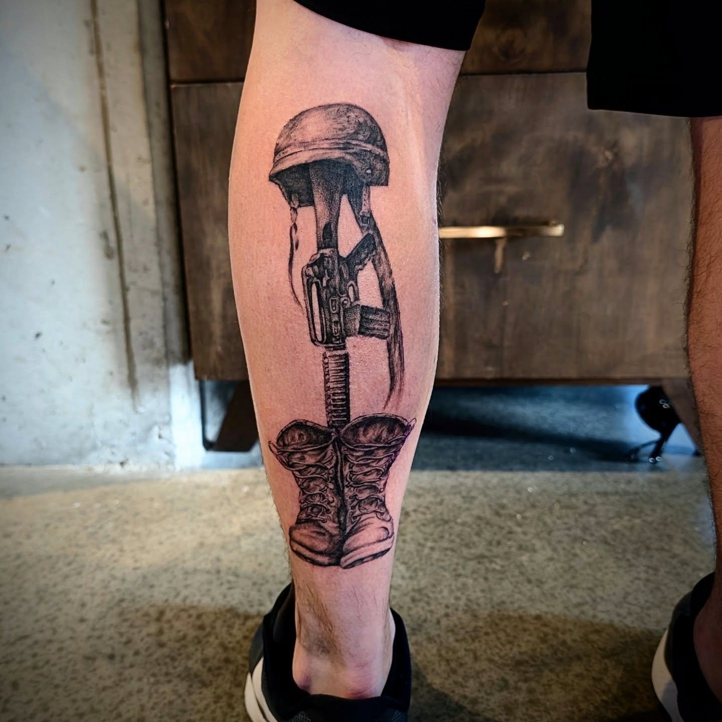Military gear realism tattoo on the calf by Drew King