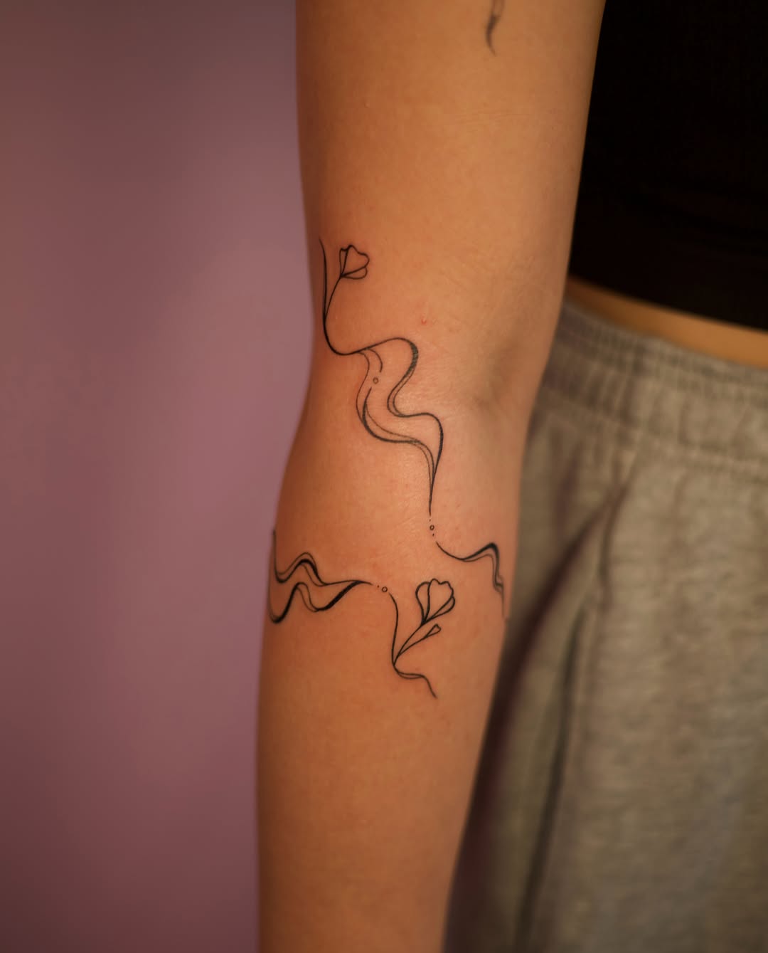 Floral design fine line tattoo on the forearm by Jess