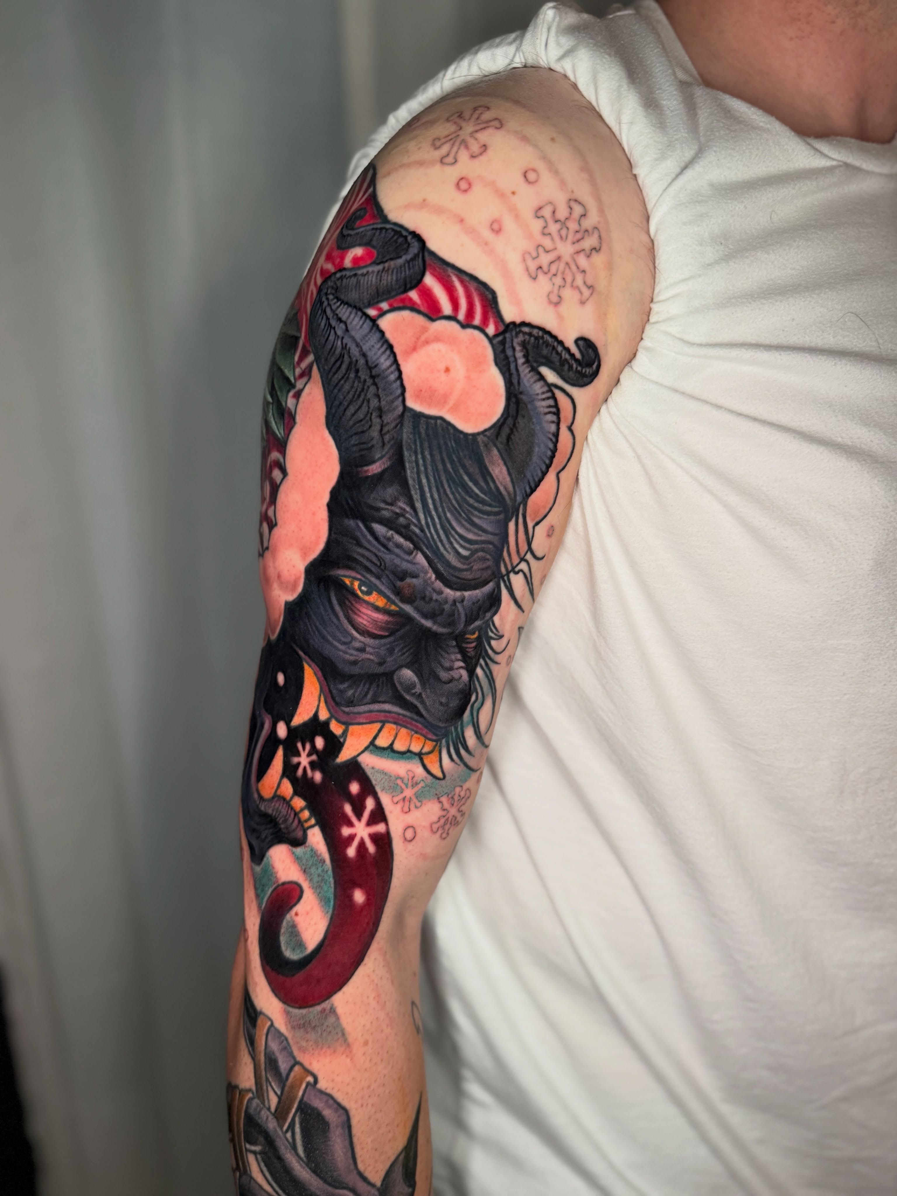 Demon mask japanese irezumi tattoo on the upper arm by Missi Blue