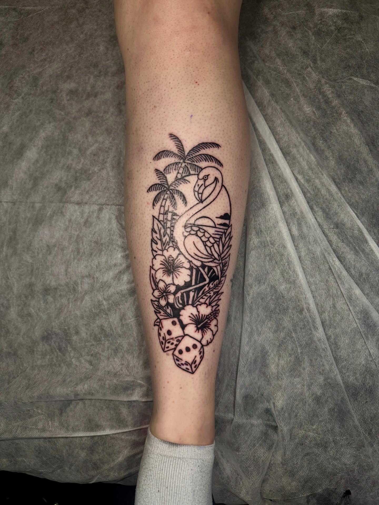 Flamingo and tropical flowers black and grey tattoo on the forearm by C.J.K. Roy