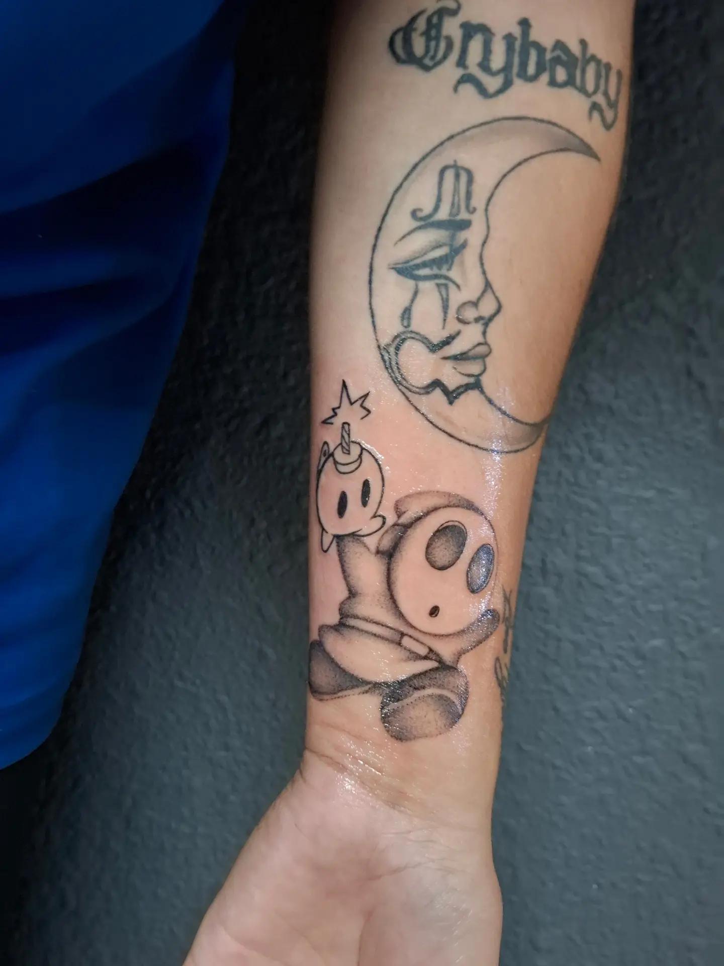 Moon and character black and grey tattoo on the forearm by ꧁༺𝔅𝔦𝔤 ℭ𝔥𝔲𝔫𝔤𝔲𝔷༻꧂, San Diego, California