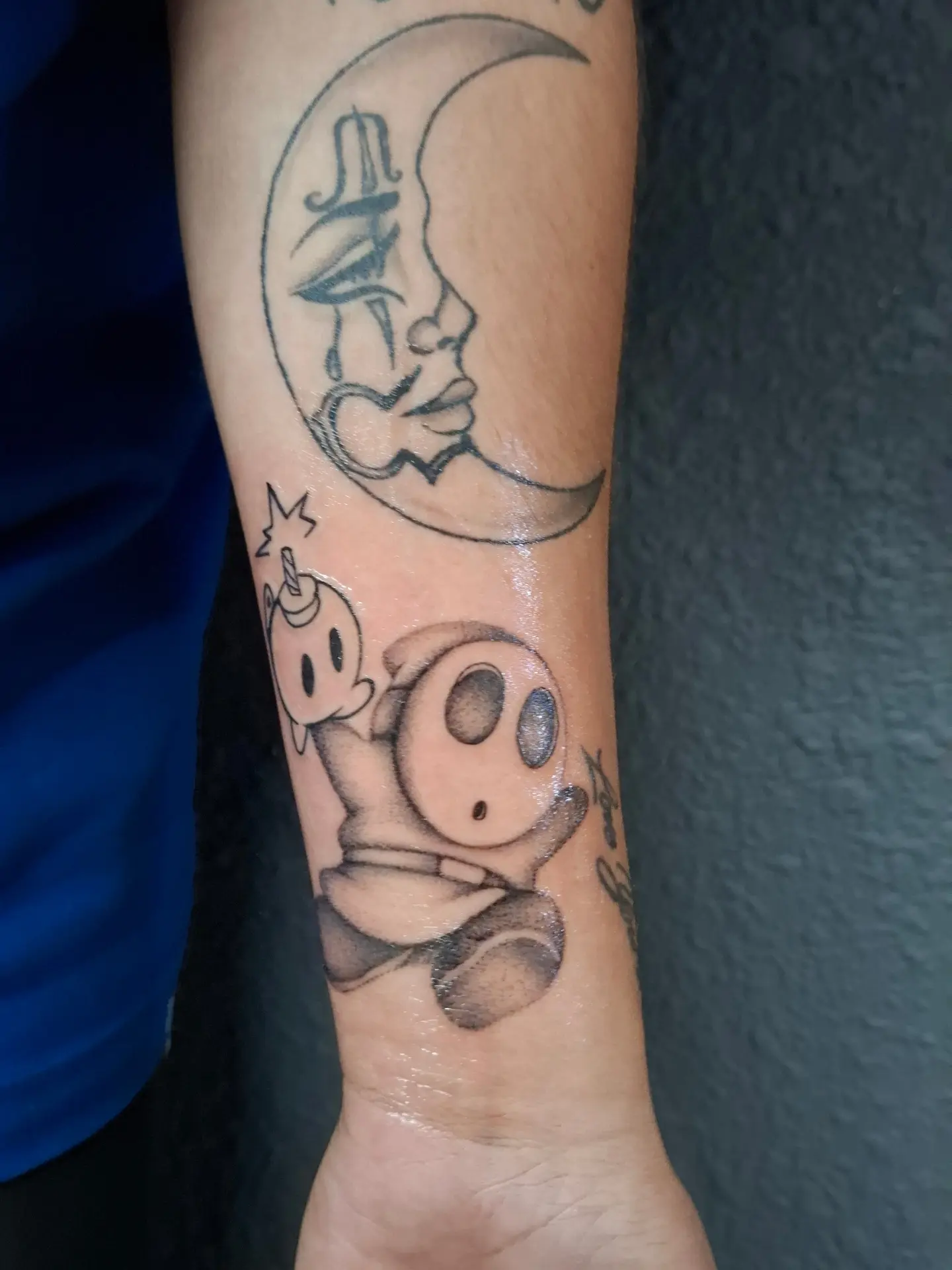 Moon and baby black and grey tattoo on the forearm by ꧁༺𝔅𝔦𝔤 ℭ𝔥𝔲𝔫𝔤𝔲𝔷༻꧂, San Diego, California