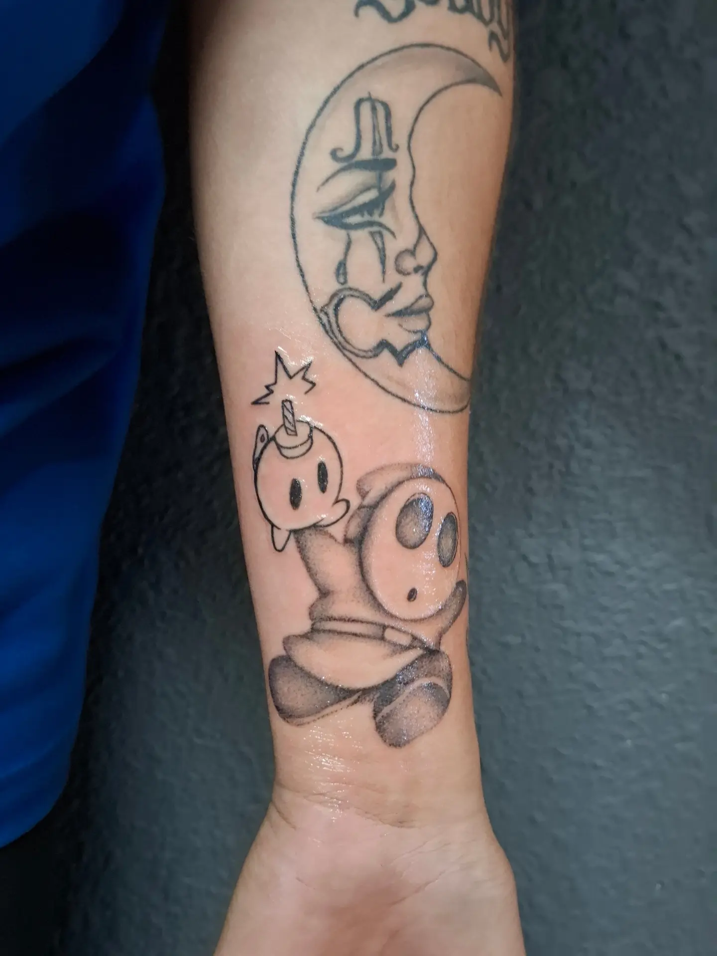 Moon and ghost black and grey tattoo on the forearm by ꧁༺𝔅𝔦𝔤 ℭ𝔥𝔲𝔫𝔤𝔲𝔷༻꧂, San Diego, California