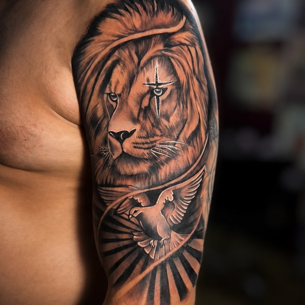 Lion and dove Chicano tattoo on the upper arm by PMU Artist