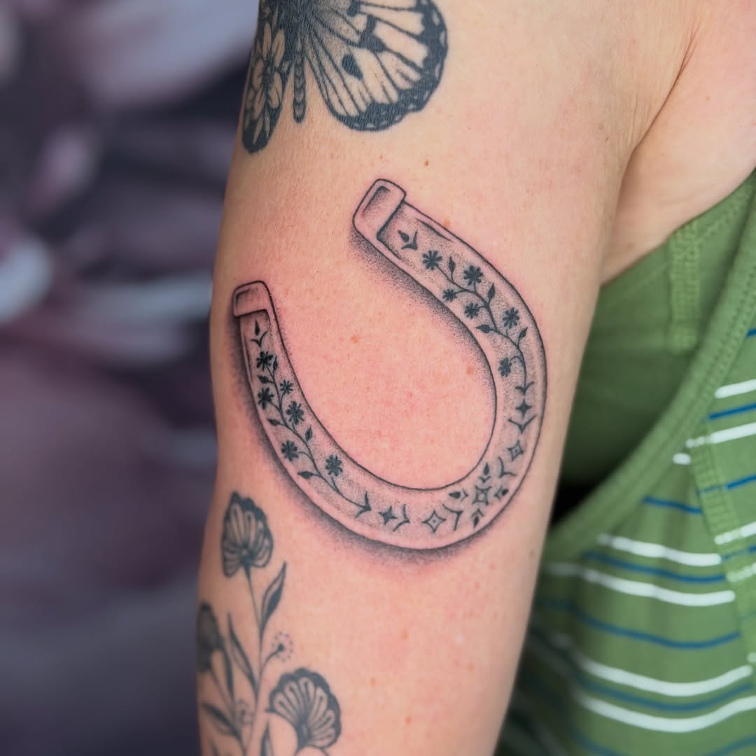 Horseshoe with floral design American traditional tattoo on the forearm by Van Cleave Aesthetics, Franklin, Tennessee
