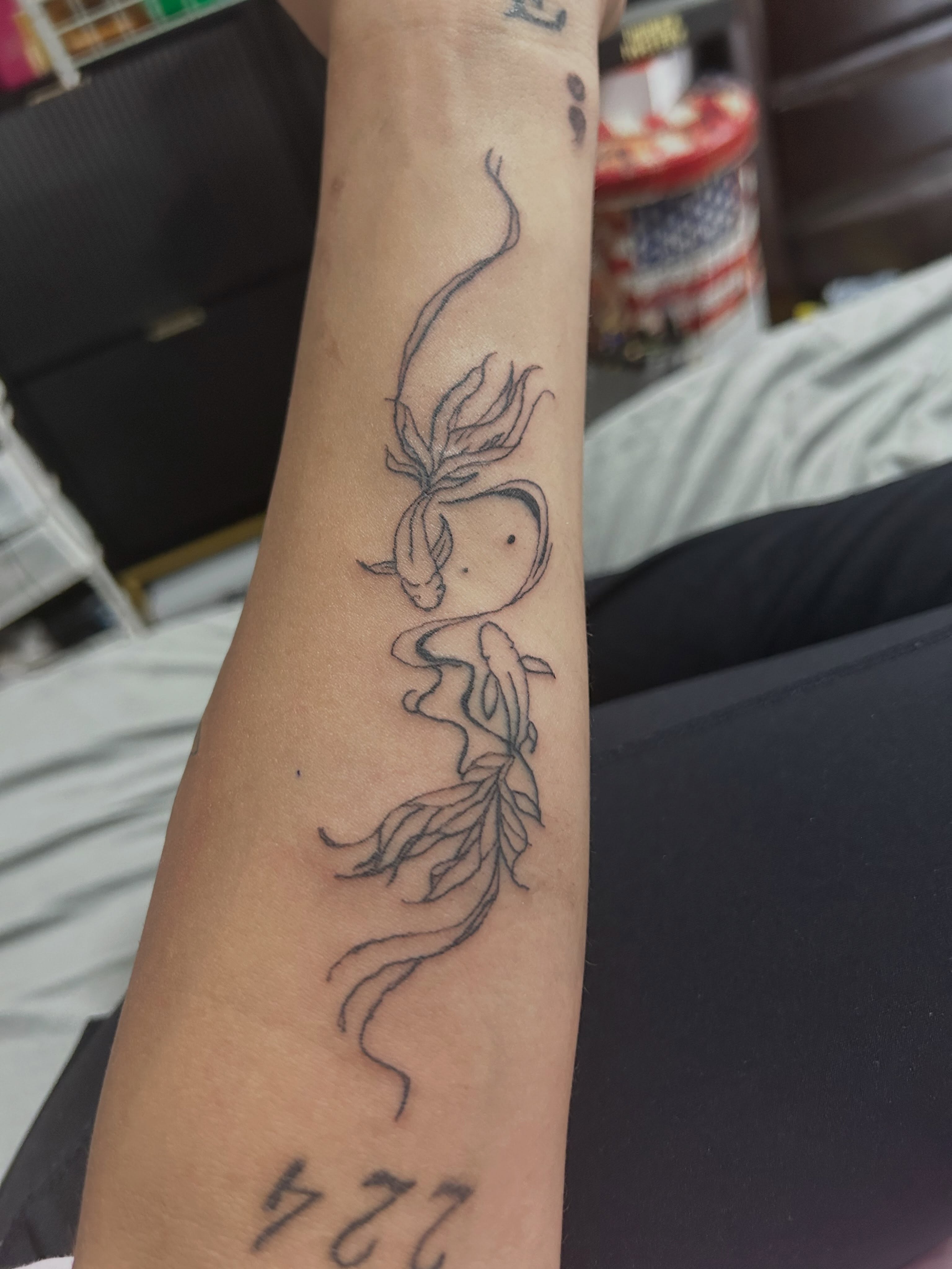 Koi fish black and grey tattoo on the forearm by The feminine ink