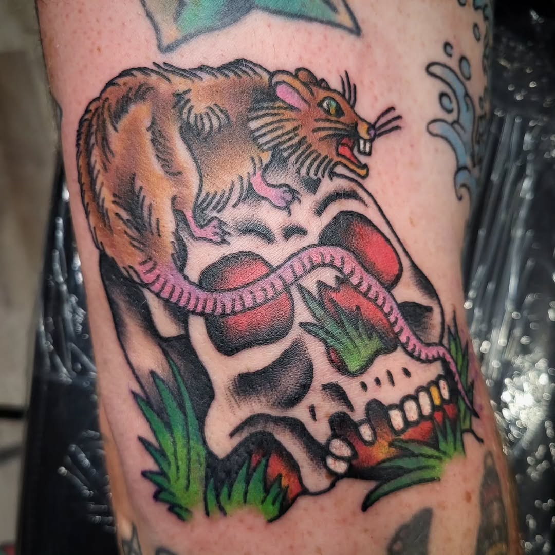 Rat on a skull American traditional tattoo on the forearm by Sloan Smith