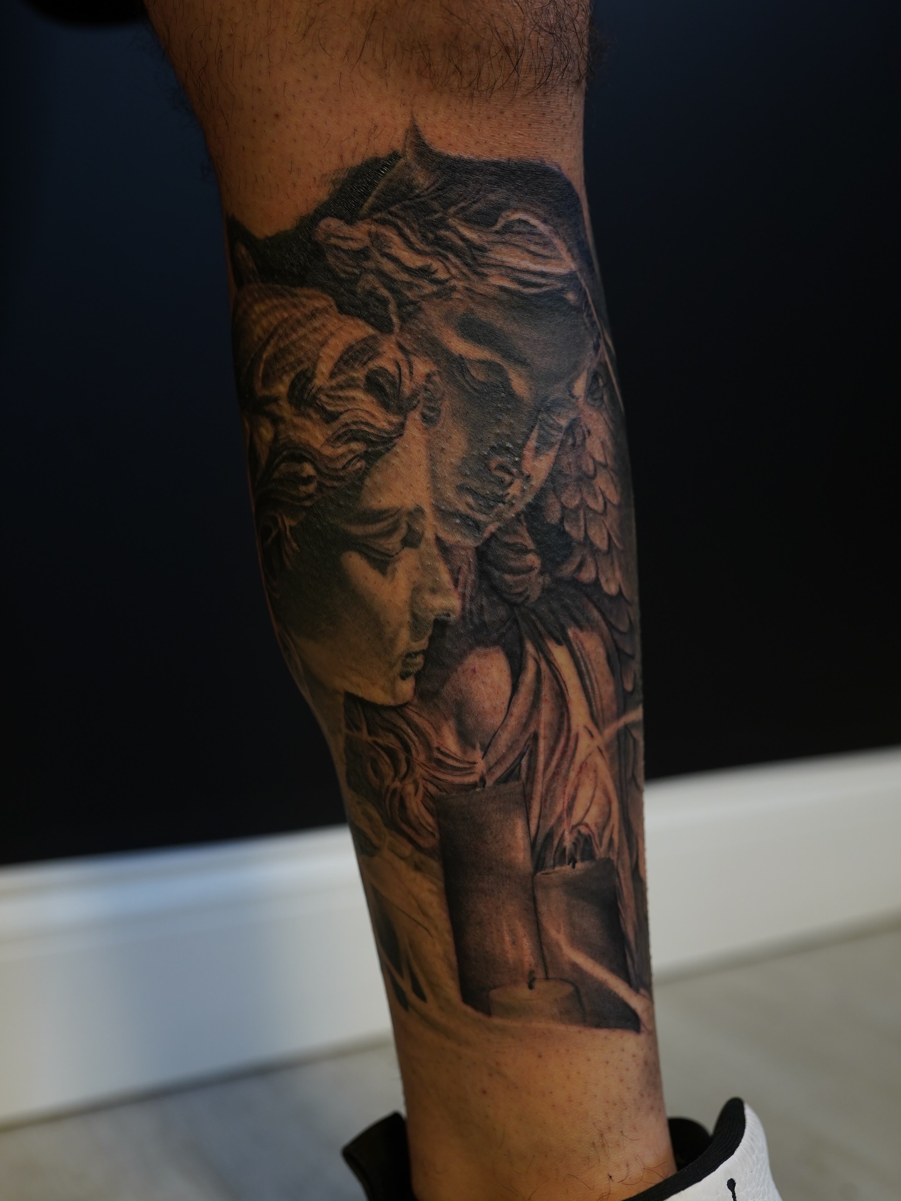 Statue black and grey tattoo on the forearm by Eric RudeInk