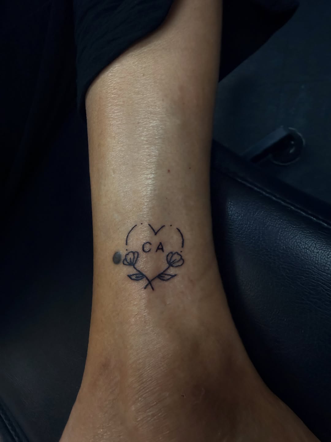 Heart with initials and flowers fine line tattoo on the forearm by Rylan Thorndyke - Tattoo Artist, Las Vegas, Nevada