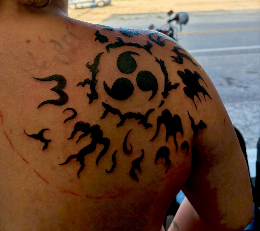 Abstract symbol tribal tattoo on the shoulder by Landon Bagley