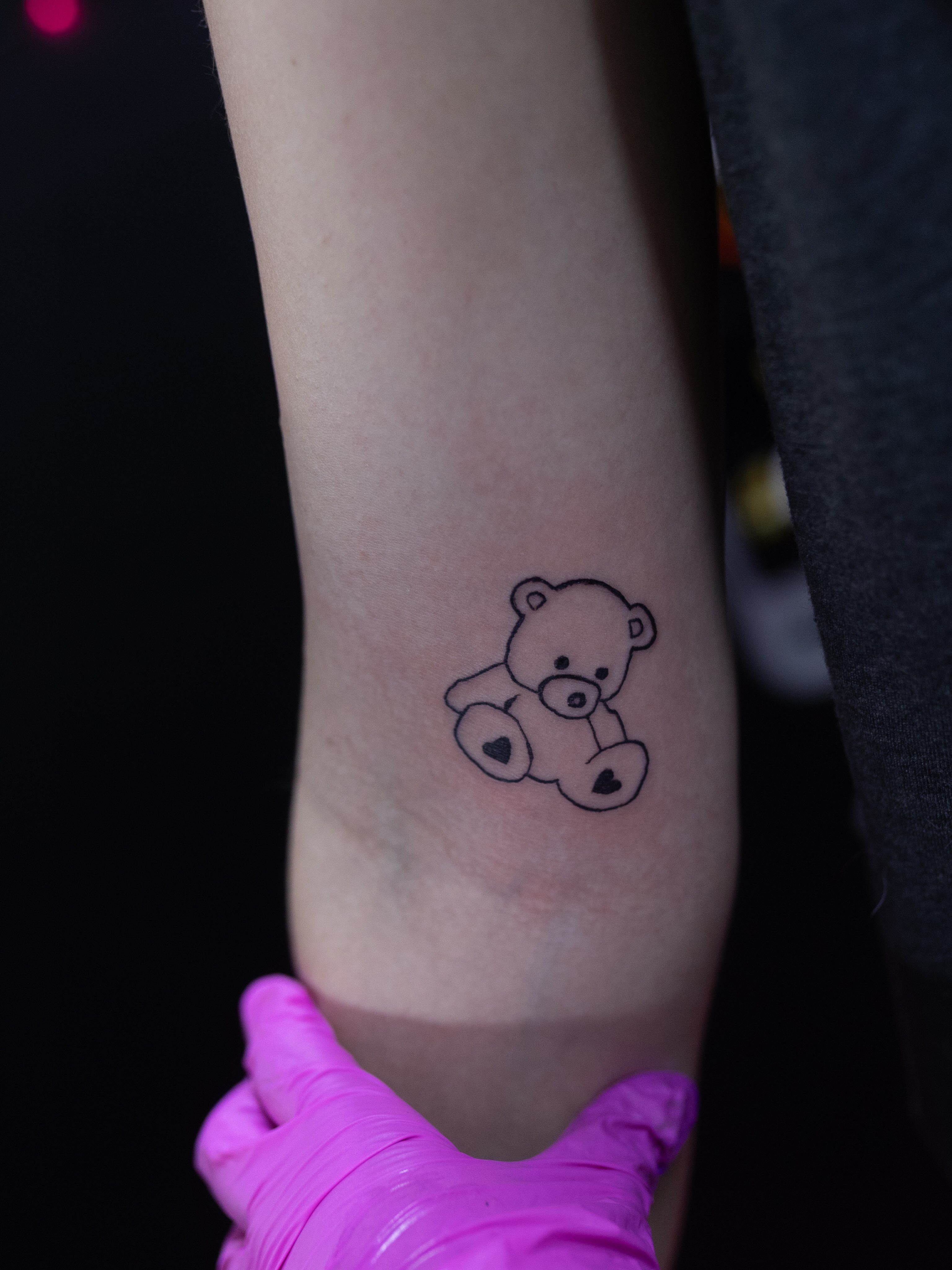Teddy bear minimalist tattoo on the forearm by Kelsie