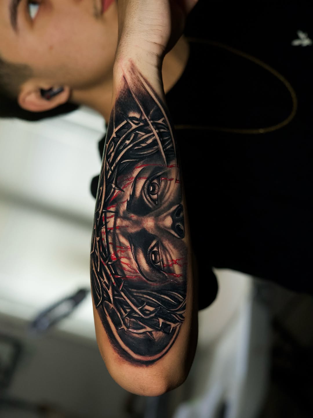 Jesus Christ with crown of thorns realism tattoo on the forearm by Insight Ink Tattoo