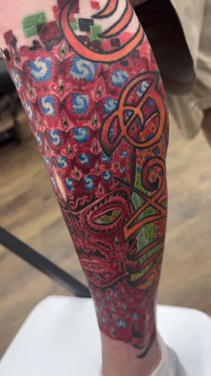 Watercolor tattoo on the leg by Bryan Parsons