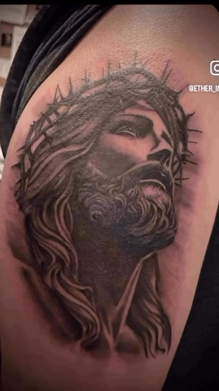 Jesus Christ portrait tattoo on the upper arm by Erik Pagtakhan
