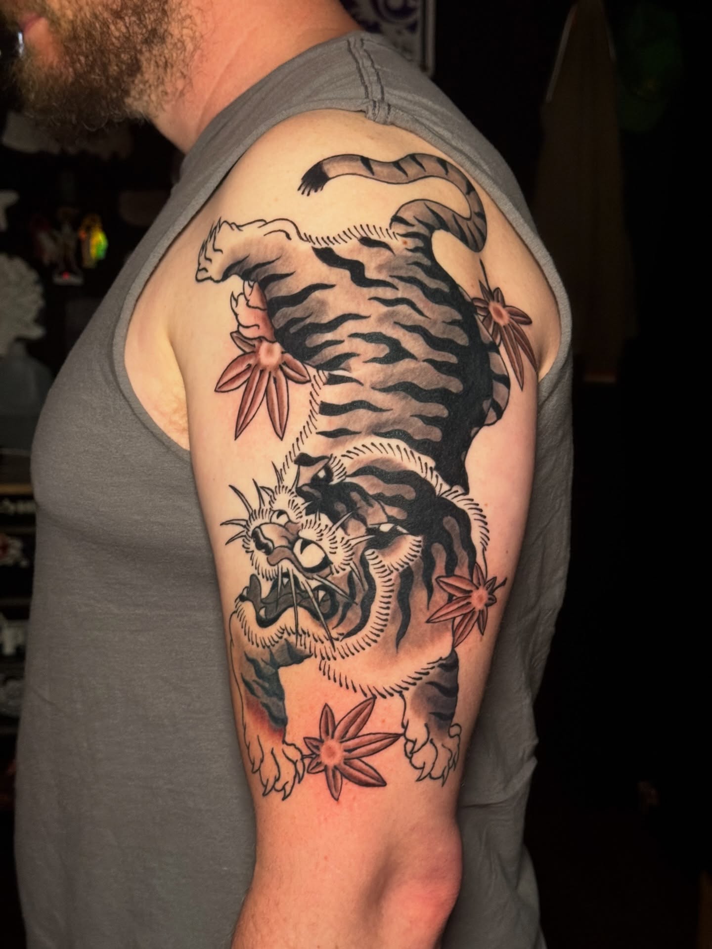 Tiger and flowers American traditional tattoo on the shoulder by Matthew - Tattoo Artist
