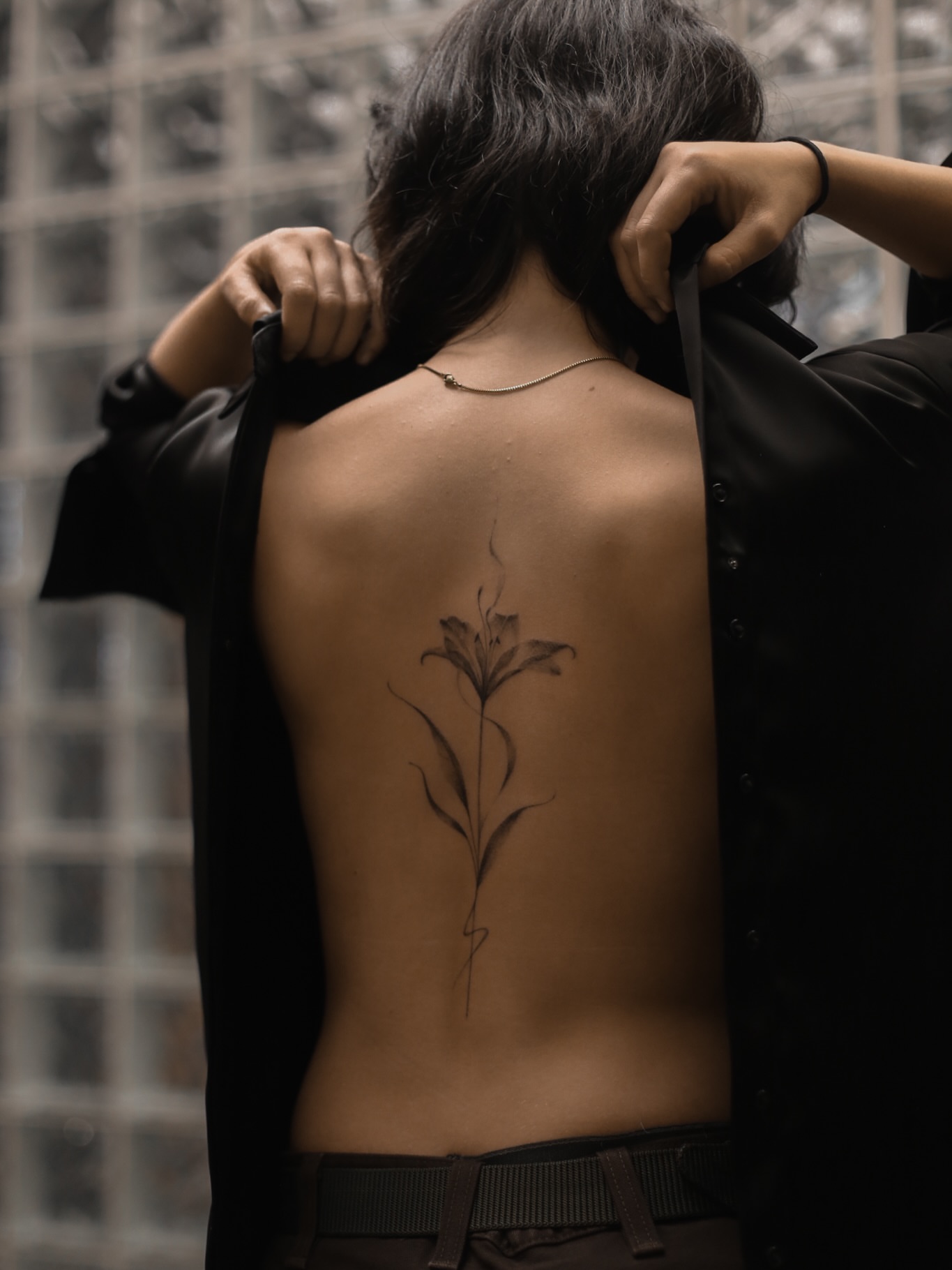 Lily black and grey tattoo on the back by Inna Petrova, Kitchener, Ontario