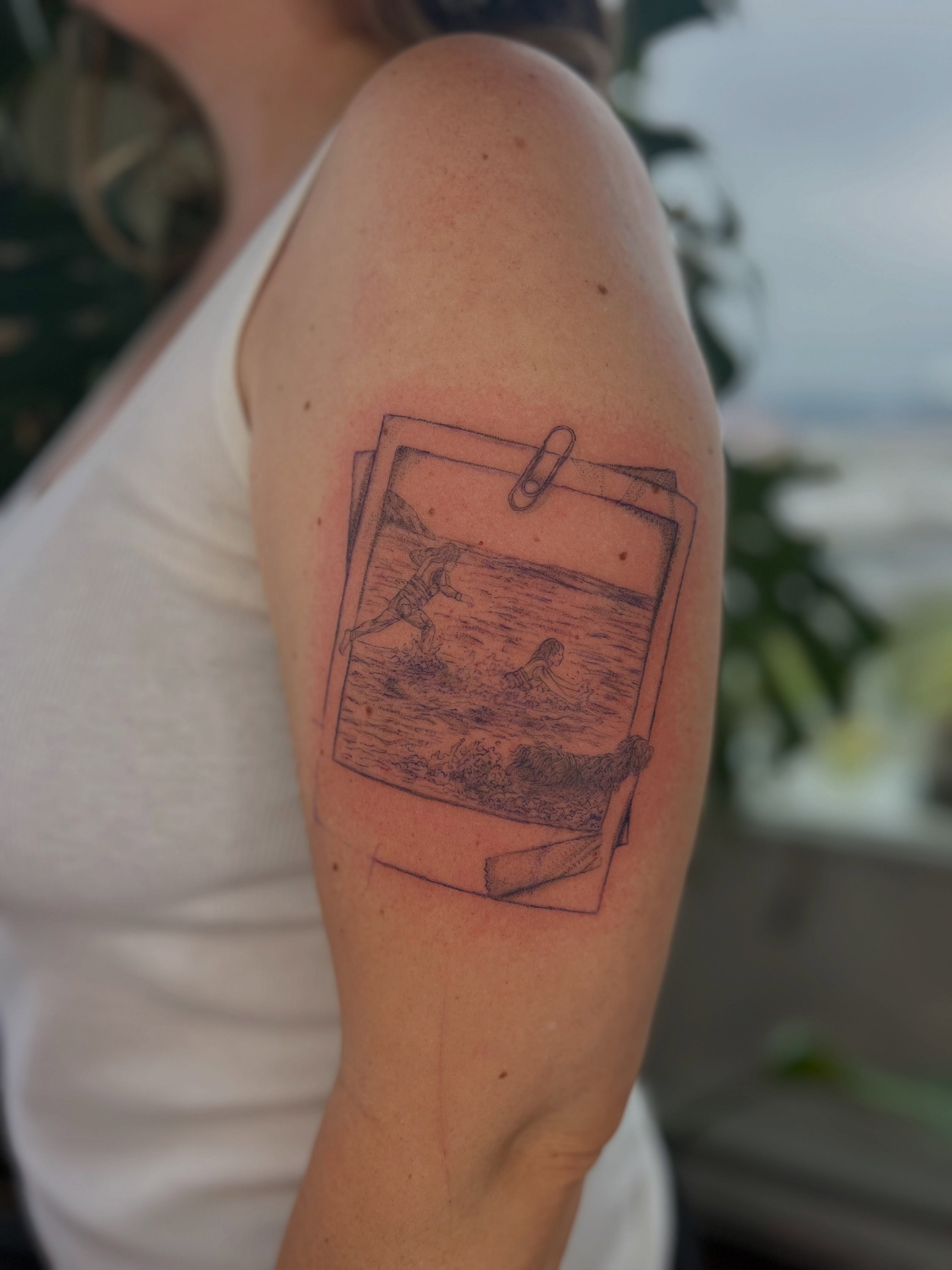 Beach scene black and grey tattoo on the upper arm by Jordi WA Tacoma Tattooer