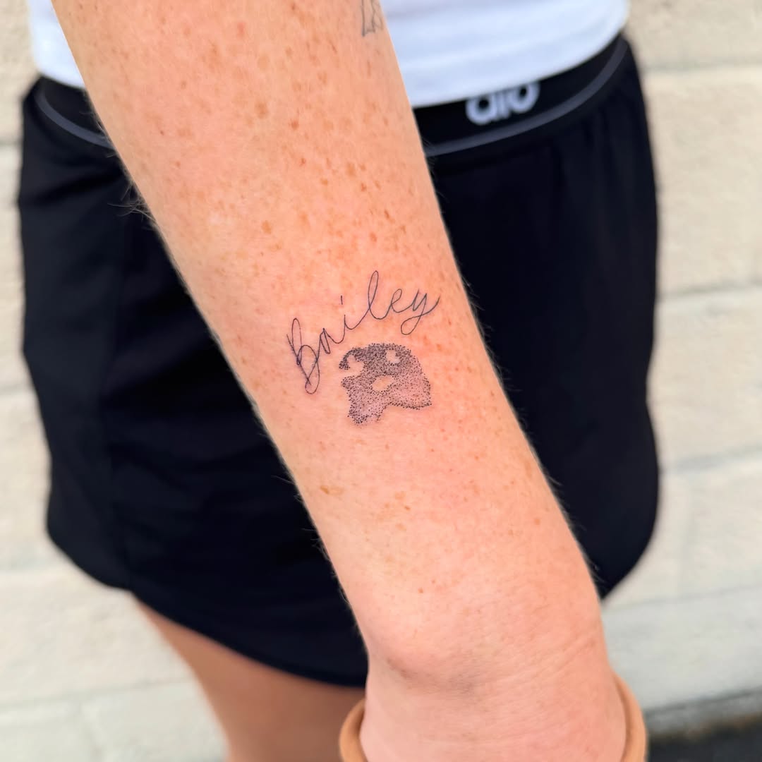 Paw print and name lettering tattoo on the forearm by Madison Davenport, Saddle Brook, New Jersey