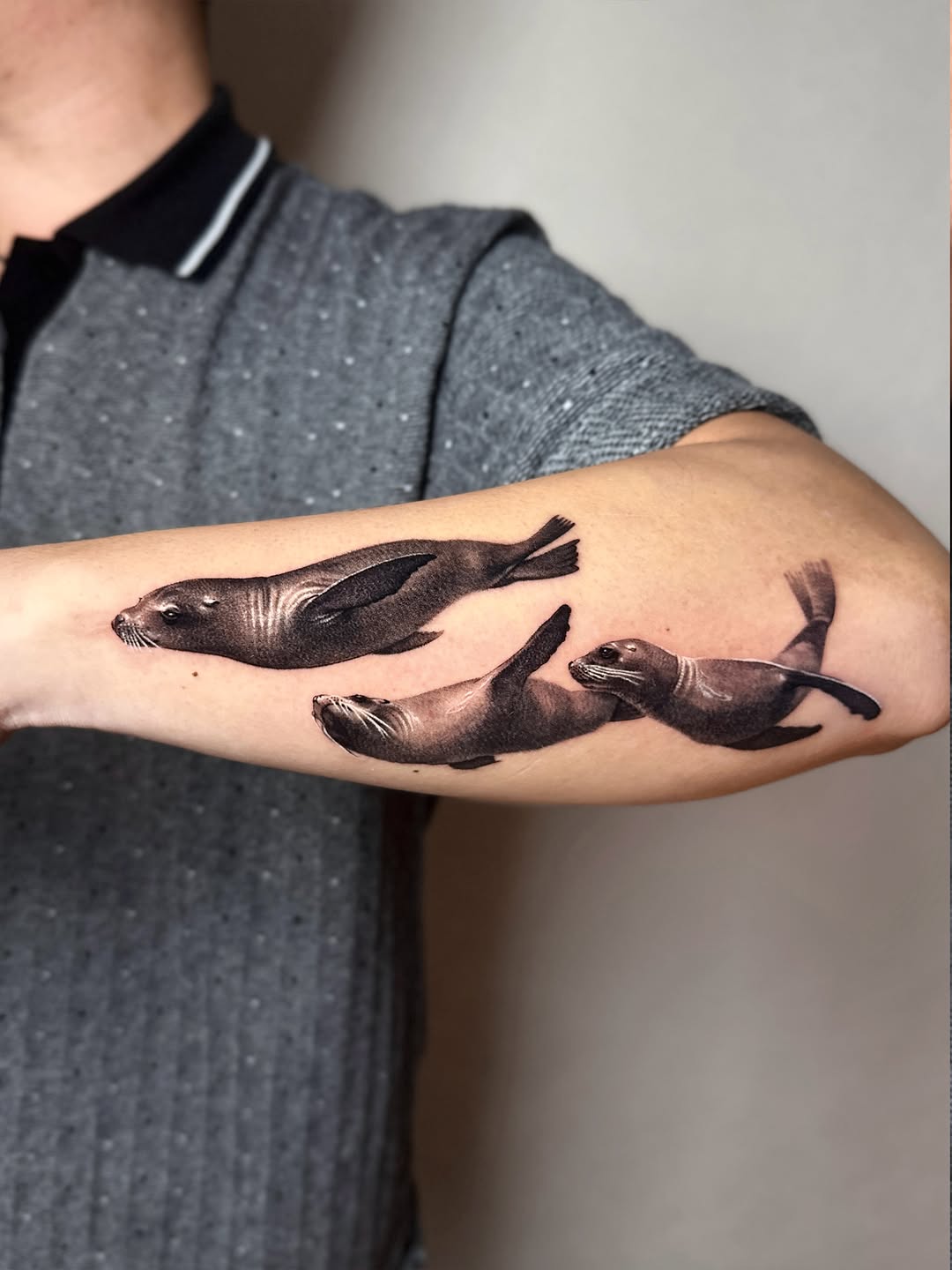 Three seals fine line tattoo on the forearm by Saru
