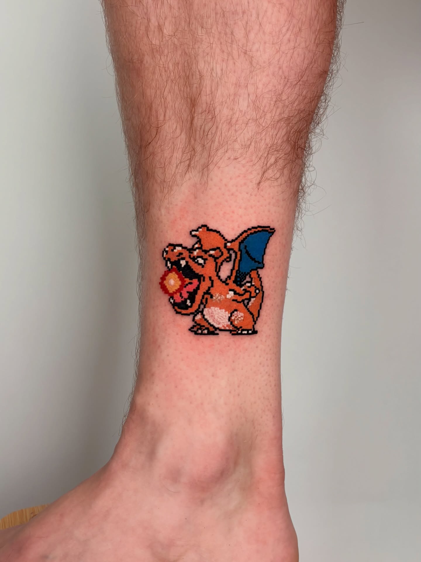 Charizard dotwork tattoo on the calf by Rami, Maden🇰🇷