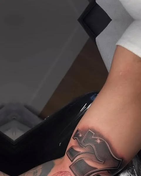 Stylized letters Chicano tattoo on the forearm by Magdalena Davis