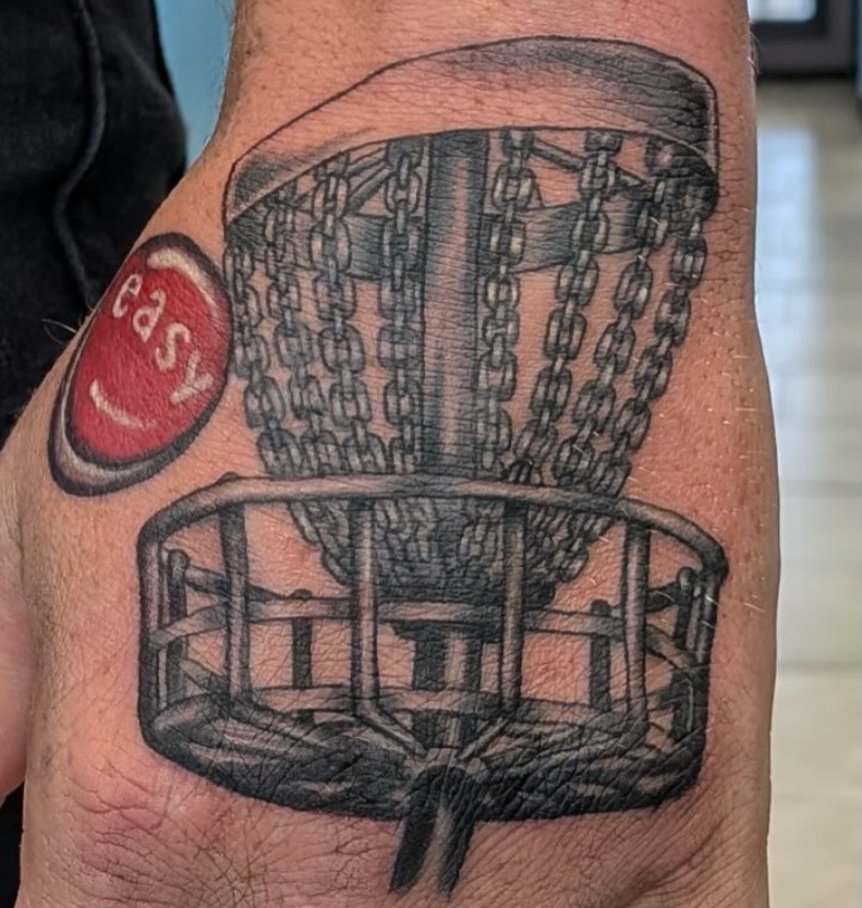 Disc golf basket tattoo on the forearm by Bryant Johnson