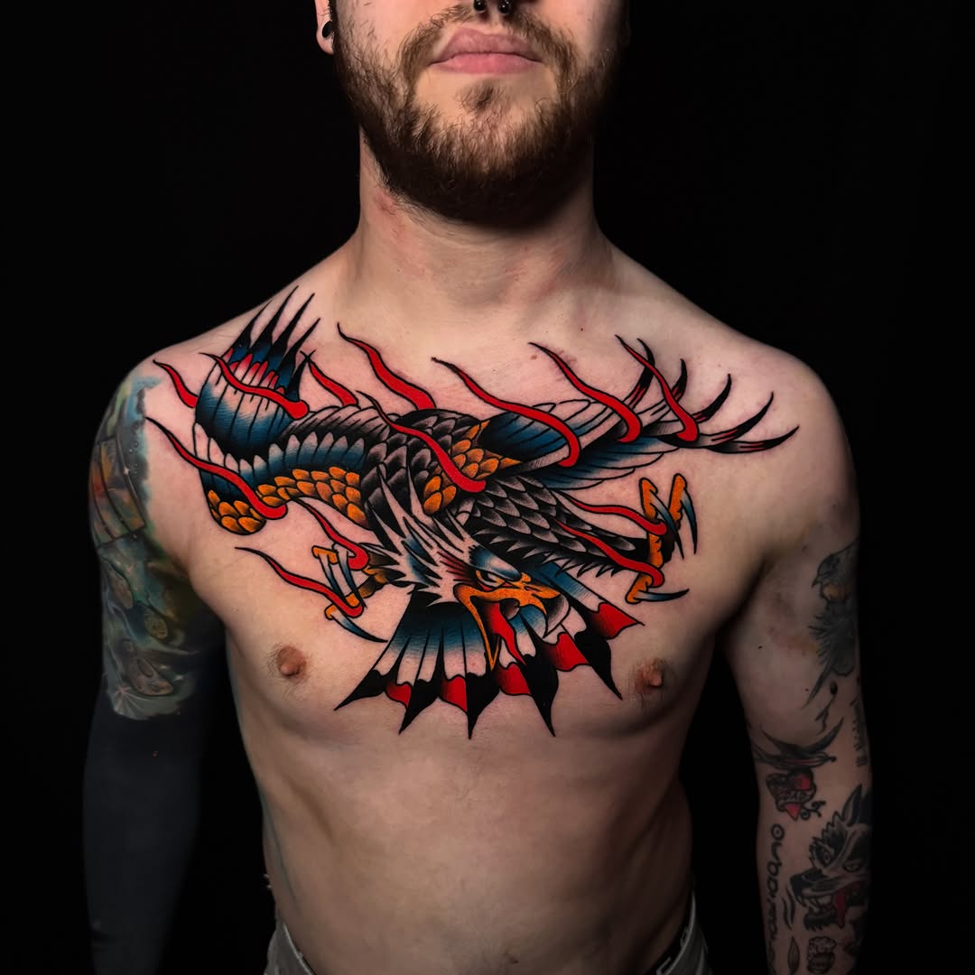 Eagle with flames American traditional tattoo on the chest by Nate Masi