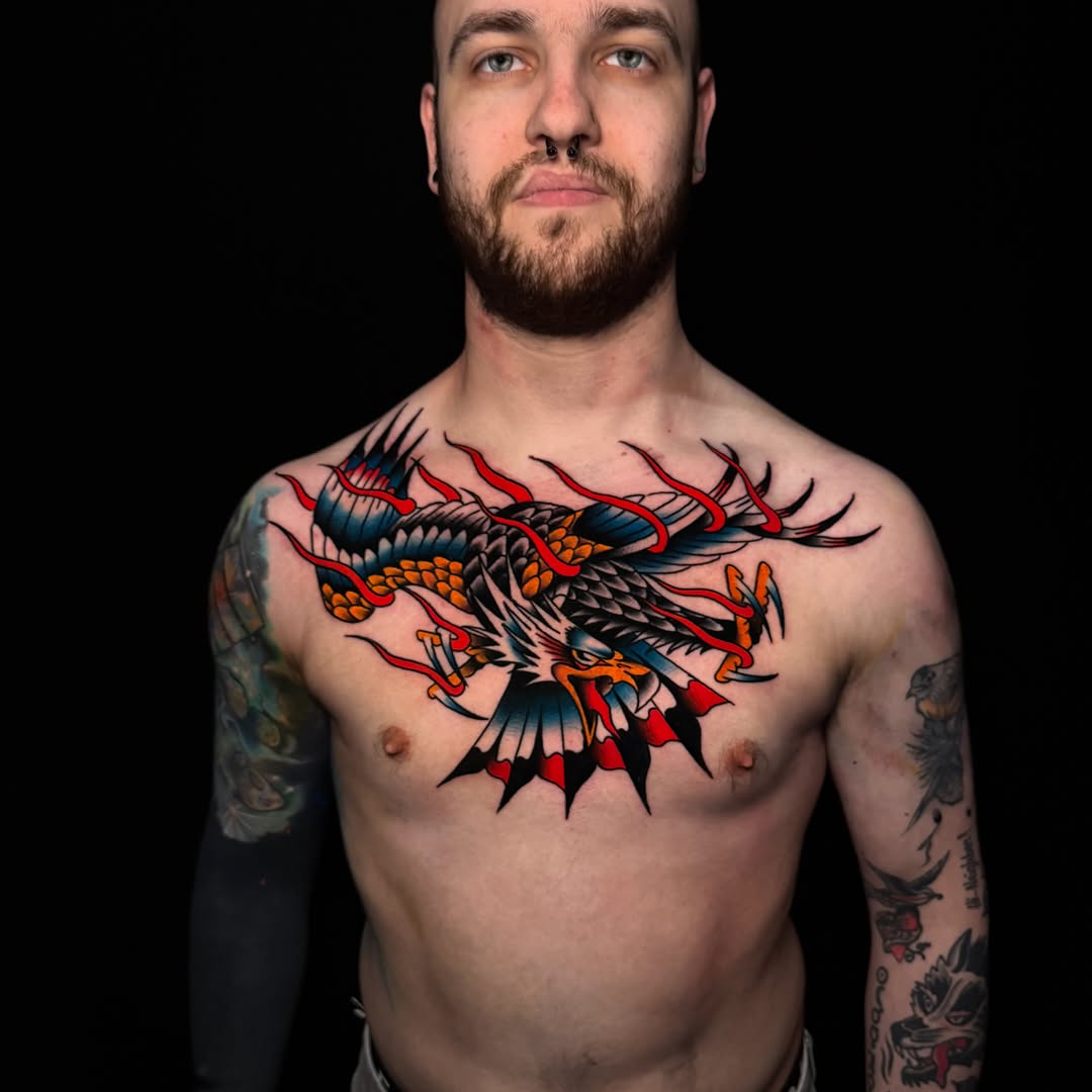 Eagle with flames American traditional tattoo on the chest by Nate Masi