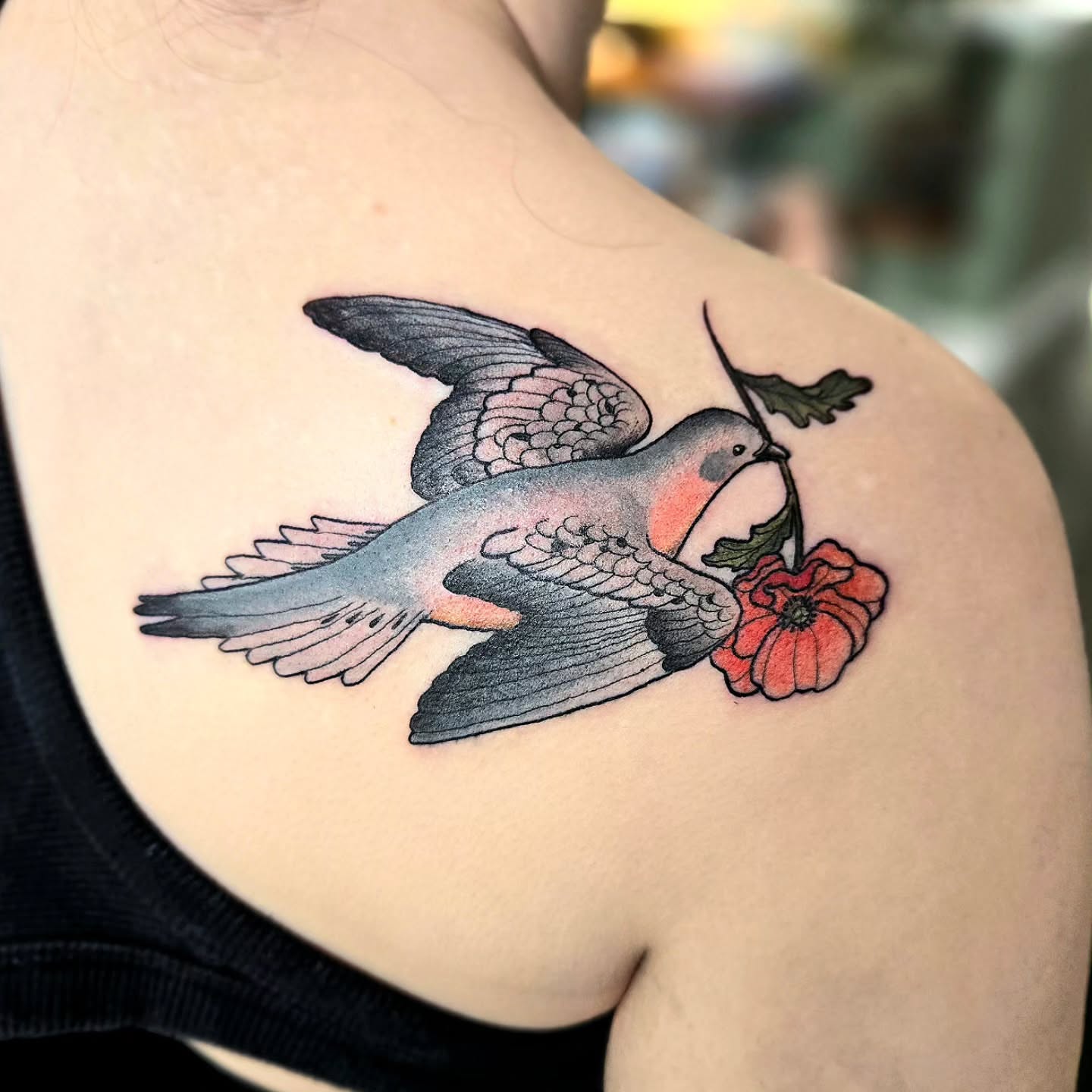 Bird and flower American traditional tattoo on the shoulder by Amanda Hinrichs