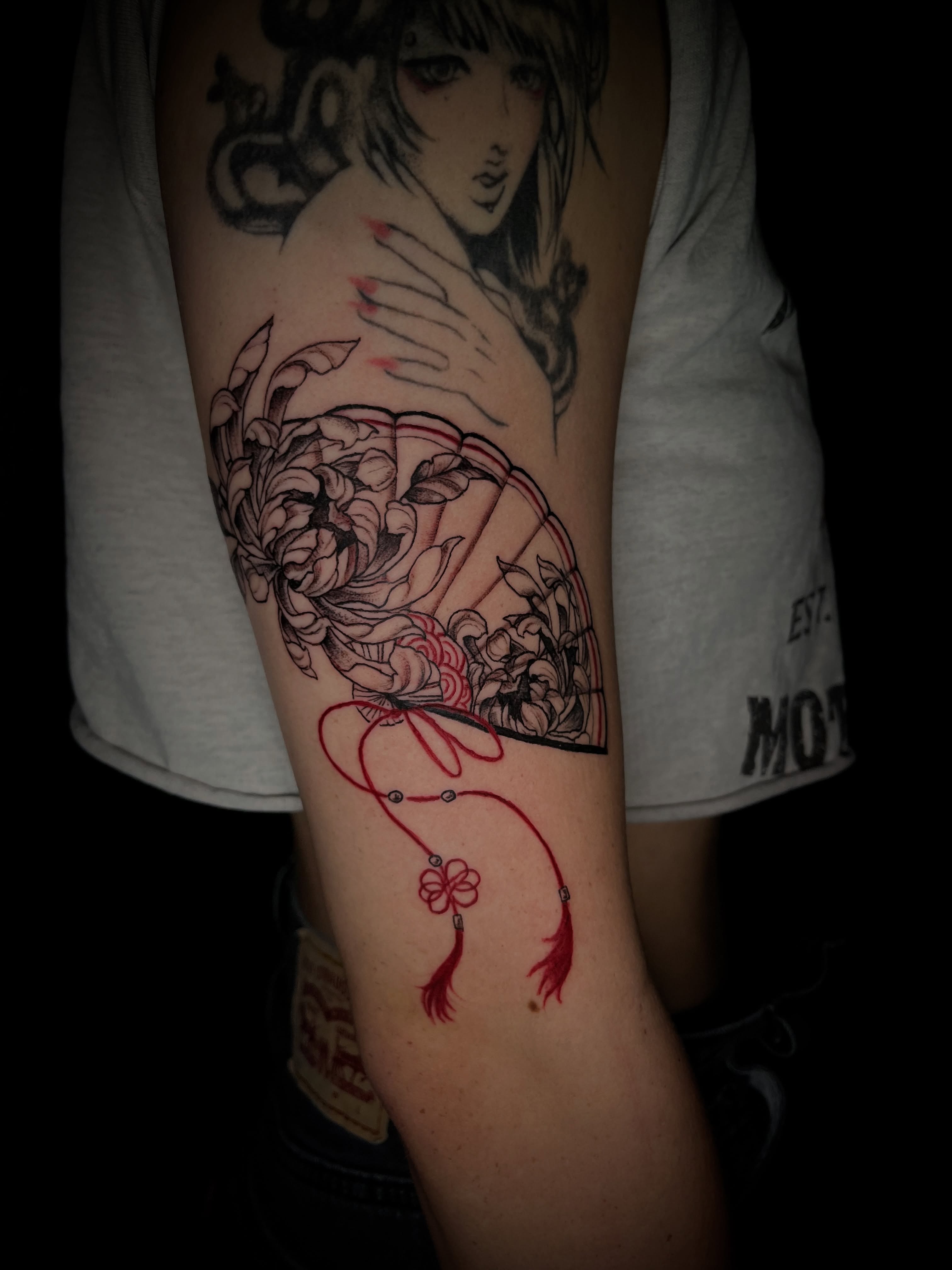 Anime-style girl with fan anime tattoo on the forearm by bev