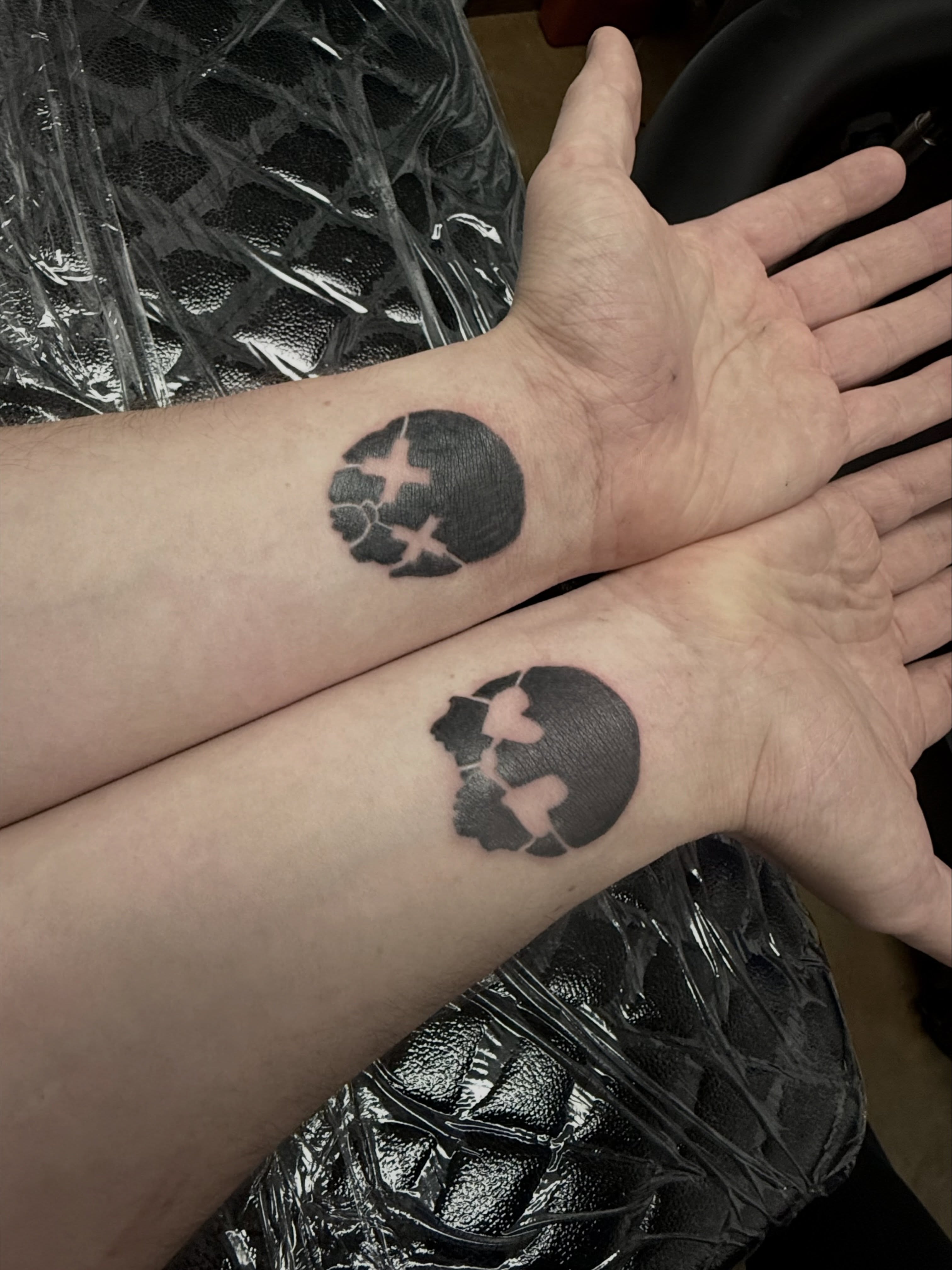 Circle with cross black and grey tattoo on the forearm by Shay - Mandeville Tattoo Artist