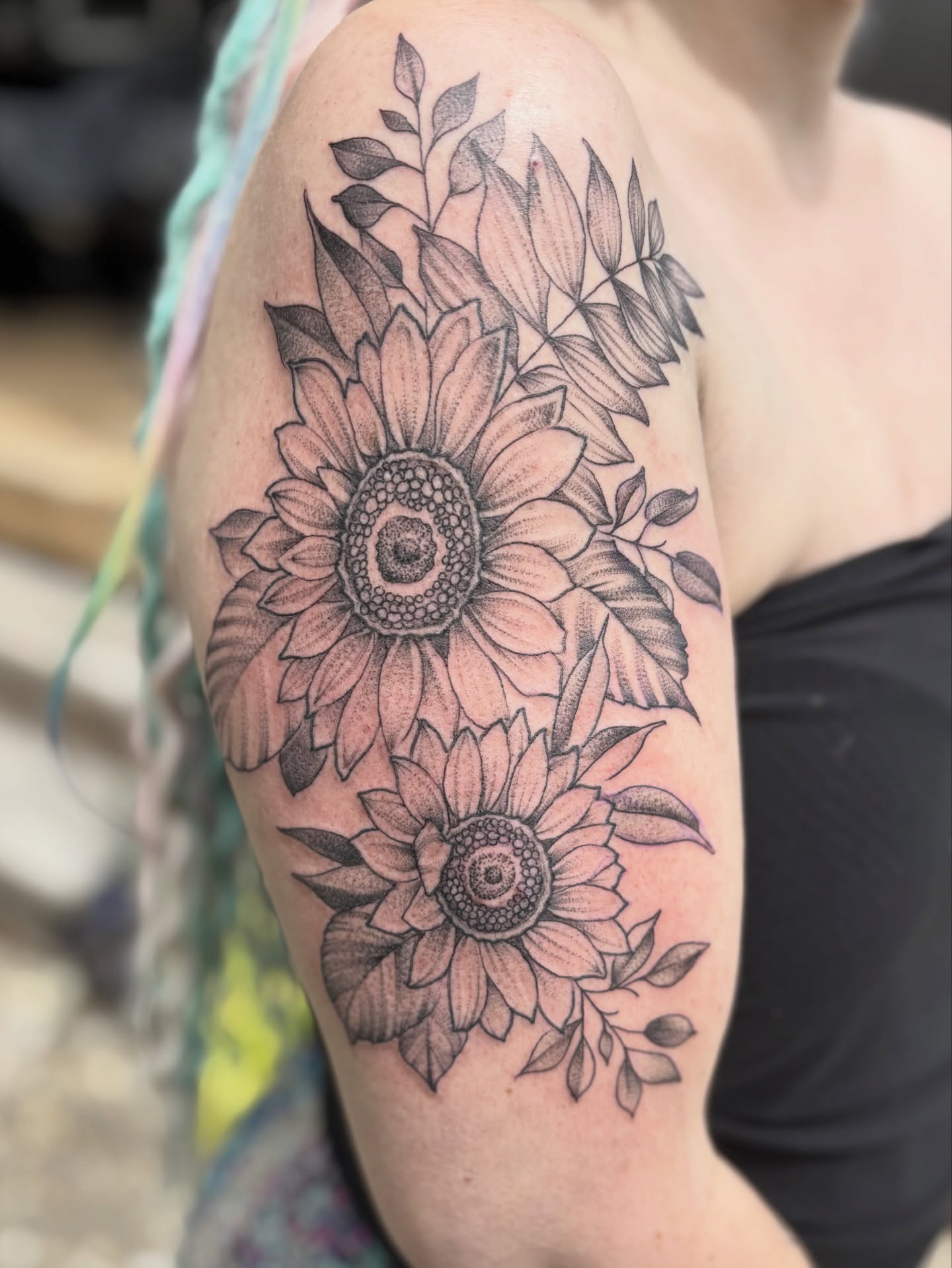 Sunflowers dotwork tattoo on the upper arm by Komfort Kristy