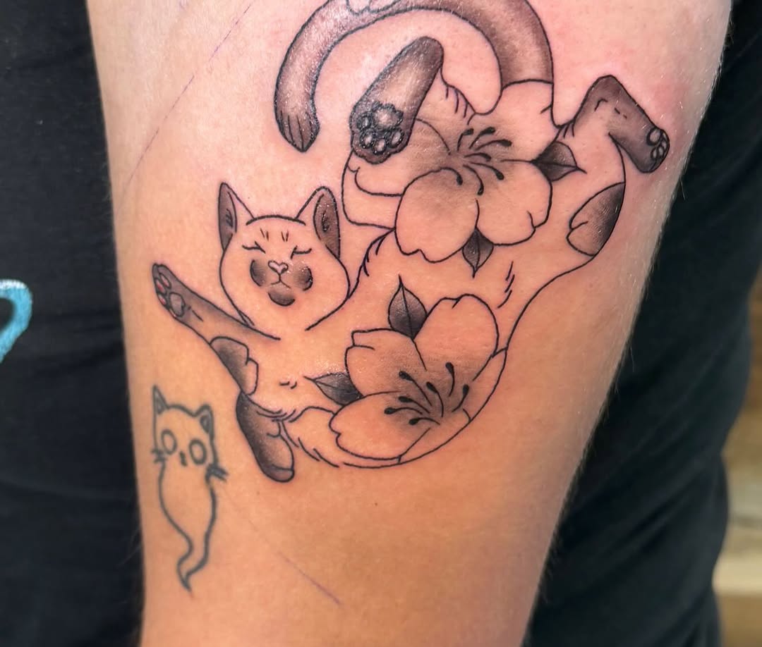 Cat and flowers fine line tattoo on the forearm by Selena Haydock