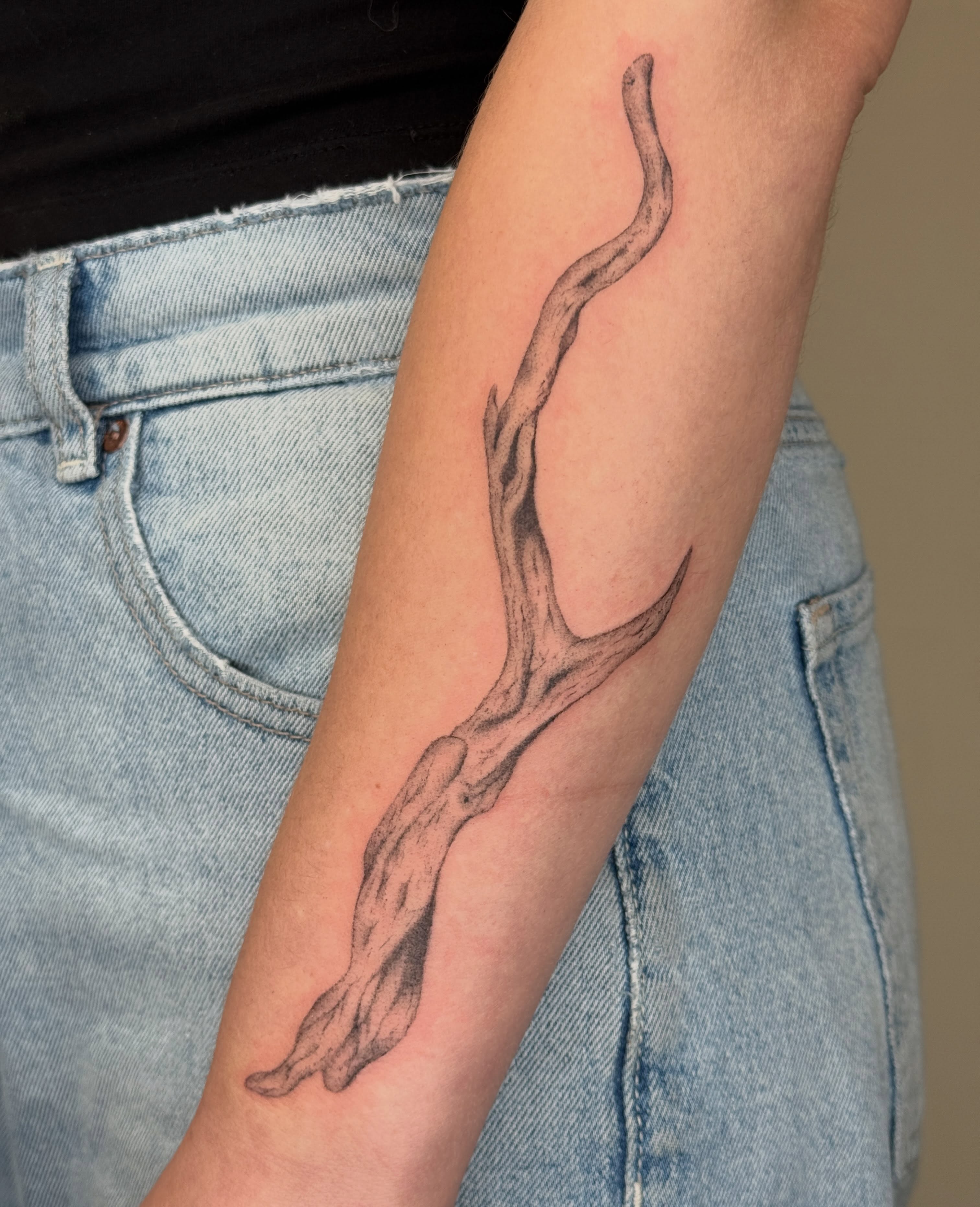 Twisted branch black and grey tattoo on the forearm by Monica Reynolds