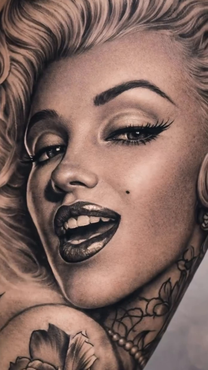 Marilyn Monroe portrait Chicano tattoo on the upper arm by Mak$ Brand